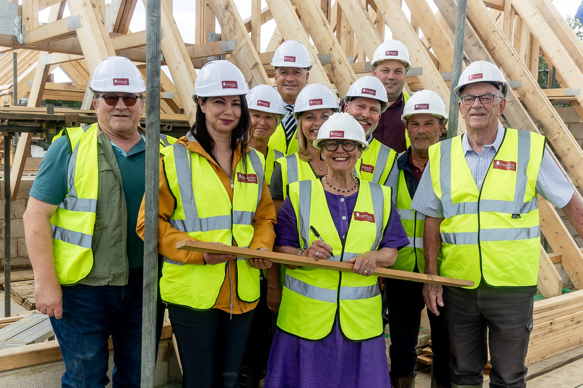 Westbury Mayor Cllr Jane Russ, Westbury Shed and Westbury Yarn Bombers join Newland Homes to mark reaching the highest point of Heron Rise