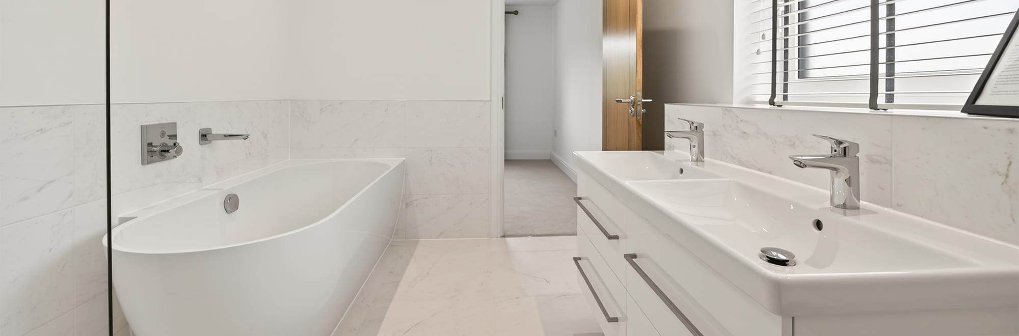 Ensuite bath and shower room at Cherringtons by Newland Homes with twin vanity units