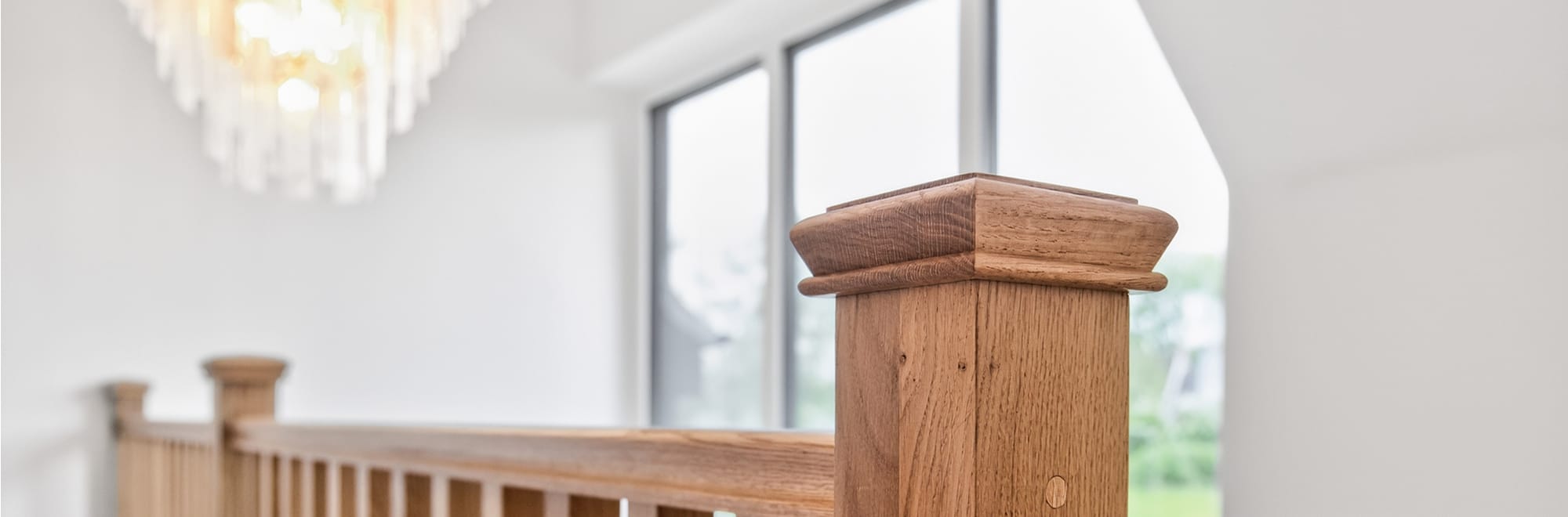 Staircase with galleried landing and panoramic full height window at Cherringtons by Newland Homes